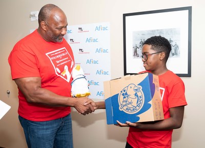 10 year old sickle cell patient from Children's National Hospital Kendric Comer receives a My Special Aflac Duck from Brad Knox, Senior Vice President and Counsel for Aflac's Federal Relations department during Aflac's commemoration of World Sickle Cell Day at Nationals Park in Washington, DC. (PRNewsfoto/Aflac)