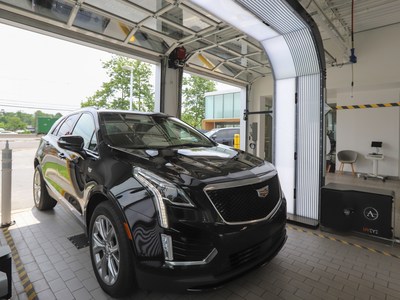 An automated UVeye vehicle inspection takes place at a Cadillac dealership.