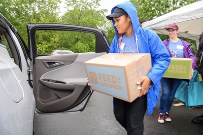 (Credit: Chip McCrea) A Dulles Corridor family receives food and essentials as part of Summer Food Distribution program run by StarKist® , Feed the Children and Cornerstones.