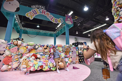 Fans dive into the Squishmallows human claw arcade experience at VidCon US in Anaheim California.