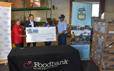 Perdue Farms delivered a $25,000 grant and 10,000 pounds of chicken products to support the Foodbank of Southeastern Virginia and the Eastern Shore’s backpack program and efforts to feed food insecure families. From left to right are Colleen Brennan, foodbank branch manager in Tasley; Christopher Tan, president and CEO of the Foodbank of Southeastern Virginia and the Eastern Shore; Kim Nechay, executive director of the Perdue Foundation, and Perdue truck driver Keith Clark.