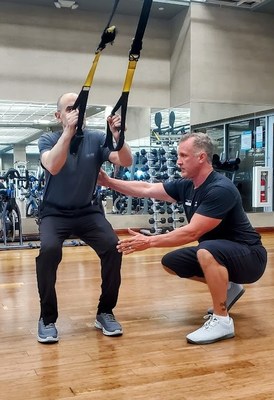 Jason Stella, an ARORA certified trainer for Life Time, coaches a member on proper form.  Stella is also the National Education Manager for Life Time and created the certification and content for all Life Time ARORA personal trainers.