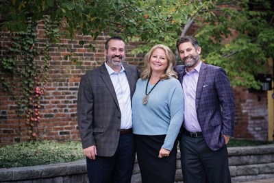 From left to right: William Kamery, Bridget Cunningham, and John King outside of Dakota Wealth Management's office at The Foundry, 432 N. Franklin Street, Suite 80.