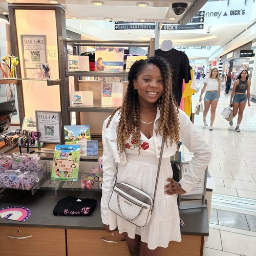 Teen Entrepreneur & Author April Pelton next to her products at Trail Blaze Shop at Stonebriar Mall in Frisco. Serving youth in the DFW Metroplex ages 12-19. It's located on the 1st floor of Stonebriar Mall between Forever 21 and Vera Bradley.