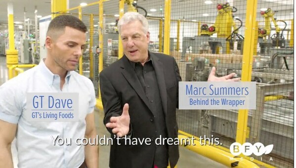 Marc Summers interviews GT Dave from GT's Living Foods in a scene from an episode of Behind the Wrapper.