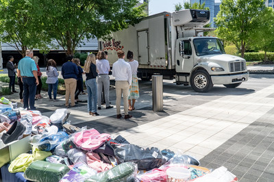 PenFed employees load the donations onto Mobile Hope’s Listen for the Honk Bus at an event held outside of Tysons headquarters on July 20.