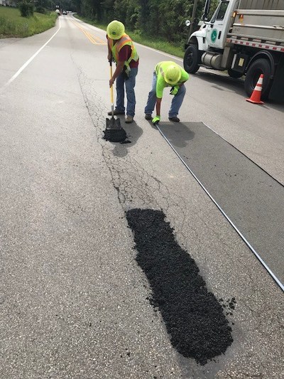 Crew applying American Road Patch. View case studies at americanroadpatch.com