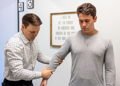 Dr. Jake Schumann helps patient at Restoration Chiropractic