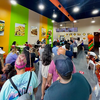 Eager customers form a long line stretching out the door as the new Shawarma press opens in Frisco.  The popular healthy and healthy Mediterranean cuisine establishment plans to open more than 100 additional quick-service restaurants in Walmart stores and stand-alone locations over the next five years