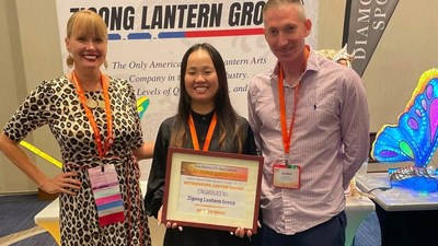 Jennifer Szabo Berthiaume - Chair of the Board FAA - hands Award to Zigong Lantern Group Meng Liu and Justin Corsa