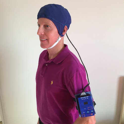 The MemorEM device for treatment of Alzheimer's Disease. The head cap contains eight electromagnetic emitters that together provide treatment to the entire brain. A control box worn on the arm contains the electromagnetic wave generator and battery. The device allows for near complete mobility during daily 1-hour treatments and is completely silent during operation.