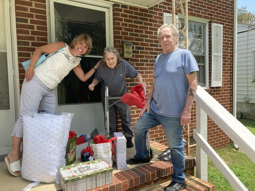 Christine King, Community Relations Director at Watercrest Richmond Assisted Living and Memory Care, delivers items to Terry and Ann Donohue who recently suffered a house fire. The Donohue's expressed their sincere gratitude to everyone involved in the Christmas in July assistance program.