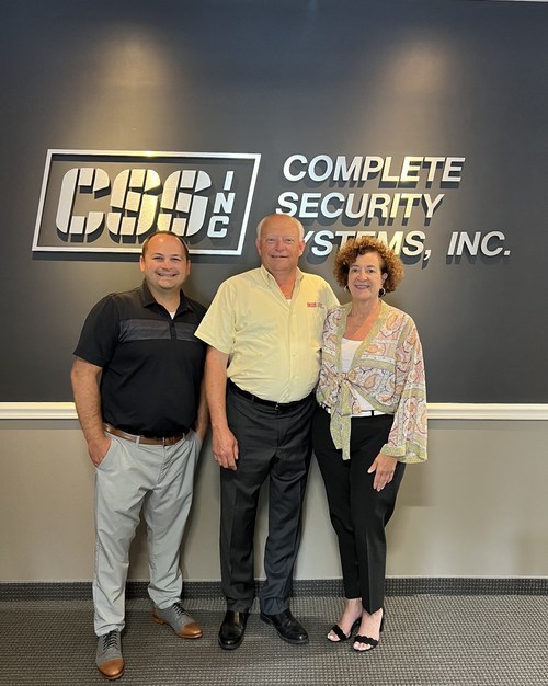 Eric Garner, CEO of Pye-Barker's alarm division, meets with Complete Security Systems' President Chris Mosley and his wife Lillian Murphy Mosley