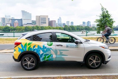 A Zipcar, creatively wrapped with iconic boats sailing on the Charles River, can be reserved by the hour or day as part of the “Drive to Donate” program, which aims to raise $20K for the Charles River Conservancy in Boston, MA