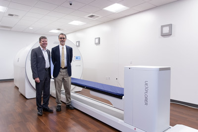 Dr. Simon R. Cherry (left) and Dr. Ramsey D. Badawi (right) standing in front of the uEXPLORER scanner.