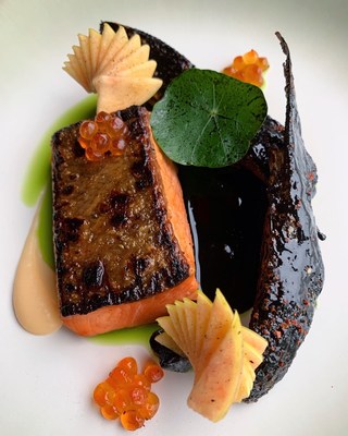 14 day dry aged Copper River Coho Salmon with slow cooked heirloom figs, pink lemonade-apple puree, grilled glazed salmon wing, and salmon roe, a prize winning dish by Chef Cesar Figueroa.
