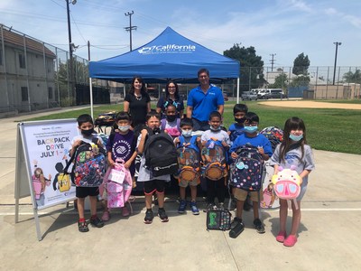(Back row, L-R) Los Angeles Boys & Girls Club Director of Operations Carlyn Oropez and California Credit Union VP School & Community Development Gloria Rogers and Vice President/Regional Manager Alex Kirrin hand out backpacks to Club Kids.