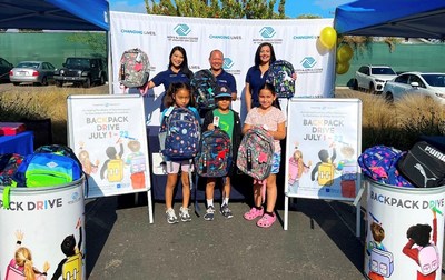 (L-R, back row) North Island Credit Union VP, Regional Manager Therese Caballes; VP, North Island Branch Manager Dino Santos; and VP, Kearny Mesa Branch Manager Nora Kulato distribute backpacks to Boys & Girls Clubs of Greater San Diego Club kids.