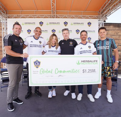 After announcing the renewal of longest jersey sponsorship in Major League Soccer at an event held at Dignity Health Sports Park on August 16, Chris Klein, President of LA Galaxy, John Agwunobi, Chairman and Chief Executive Officer, Herbalife Nutrition, Greg Vanney, Coach for the LA Galaxy,  Ibi Montesino, Executive Vice President, Distributor & Customer Experience and Chief of Staff, Frank Lamberti, Regional President, The Americas, Herbalife Nutrition, and Javier "Chicharito" Hernandez, Captain and Defender for the LA Galaxy hoist donation check for the Joint Community Partnership Fund, which gives back to underserved communities around the world.