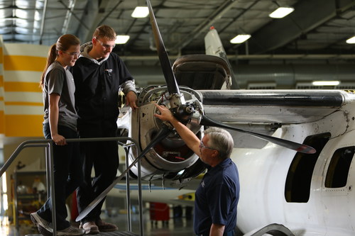 West-MEC Aviation Program Instructor Terry Menees confers with students.