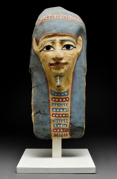 Large Egyptian mummy mask with wig, Early Ptolemaic Period, circa 300-250BC, 430mm (16.9in) x 190mm (7.5in). Provenance: Property of London gallery; ex Rhineland private collection, in Germany since before 1960. Estimate £3,000-£6,000 ($3,625-$7,250)