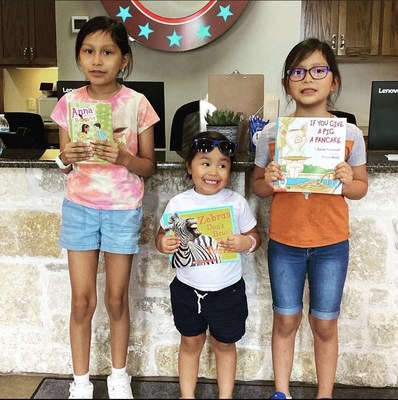 Children pick out books at a Smile Doctors affiliated practice.