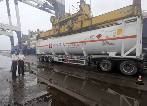 Photo shows an LNG tank container being unloaded from the deck cargo ship.