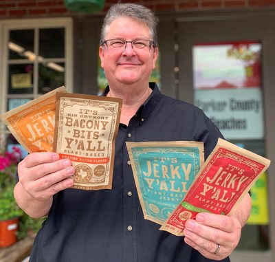CEO and Founder of All Y'alls Food, Brett Christoffel, with It's Jerky Y'alls Prickly Pear Teriyaki, It's Big Crunchy Bacony Bits Y'all toppings, and It's Jerky Y'alls Black Pepper & Sea Salt.