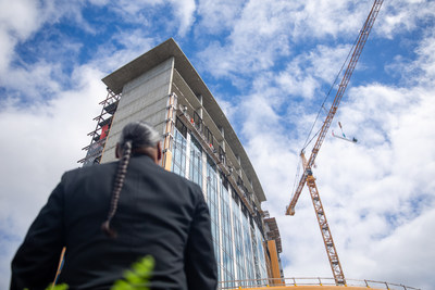 Muckleshoot Casino COO Tyrone Simmons watches as the final beam for Muckleshoot Casino’s resort tower is placed atop the 18-story structure on August 26, 2022.