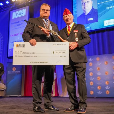 Henry Repeating Arms Company President Andy Wickstrom (L) presents a $50,000 check and a Henry Military Service Tribute Edition rifle to The American Legion National Paul E. Dillard (R) at the organization's National Convention in Milwaukee, Wis., on August 30, 2022.