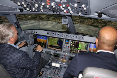 Michael Deluce, president and CEO, Porter Airlines, receives instructions inside FlightSafety International's E195-E2 flight simulator. (CNW Group/Porter Airlines)