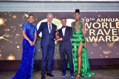 Sandals Resorts International Executive Chairman Adam Stewart and CEO Gebhard Rainer accepts the award for Outstanding Contribution to the Hospitality & Tourism Industry at 2022 World Travel Awards.
