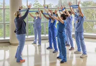 Crystal Morales of the MedStar Health Center for Wellbeing leads associates on a wellness exercise.