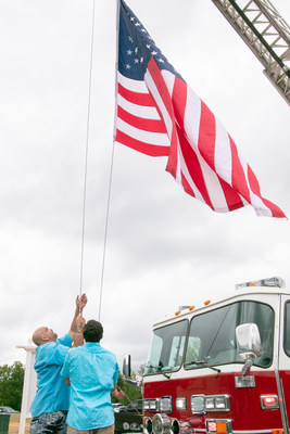 At a ceremony on September 8, former U.S. Army 82nd Airborne Division soldier George Perez and his 16-year-old son raised a US flag in front of their future homesite - being built by Mattamy Homes as part of the Operation: Coming Home program. (CNW Group/Mattamy Homes Limited)