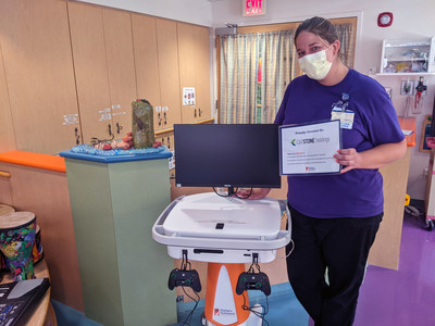 St. Louis Children's Hospital Child Life staff member standing with a GO Kart donated by CapStone Holdings Inc.