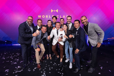 Adrian Michalcik, representing Norway, is awarded the title of world's best bartender at the Diageo World Class Global Bartender of the Year competition 2022- surrounded by members of the World Class Hall of Fame