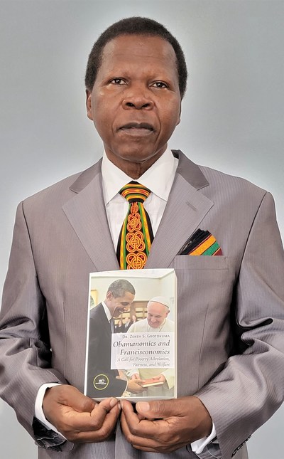 Dr. Zekeh Gbotokuma holds a copy of his new book titled, OBAMANOMICS AND FRANCISCONOMICS that he will launch at Assisi 2022 Economy of Francesco Global Event with Pope Francis.