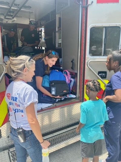 Student from Sanders Park Elementary School receives new backpack from the Sanders Park Elementary School, donated by Broward Sheriff's Advisory Council