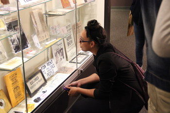 A visitor leans in to discover the background and history of some of the objects at the Jim Crow Museum.