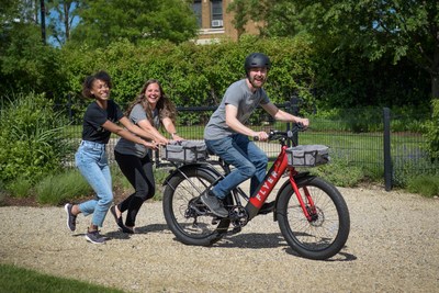 Radio Flyer team riding a FLYER M880 e-bike with accessories.