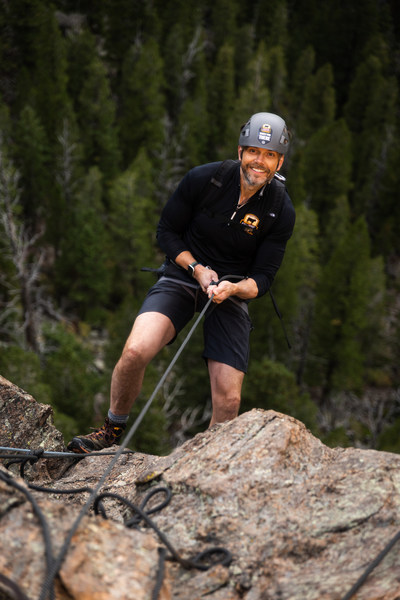 Actor, comedian and host Joel McHale performing a belayed rappel to the 100-feet high ledge where his epic dinner featuring Certified Angus Beef ® brand awaits