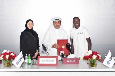 Internet sensation Khabane "Khaby" Lame, the world's most followed person on TikTok, is pictured at the official signing ceremony with Ali Rashid Al-Mohannadi, QNB Group Executive General Manager & Group Chief Operating Officer, and Heba Ali Al-Tamimi, QNB Group General Manager Group Communications
