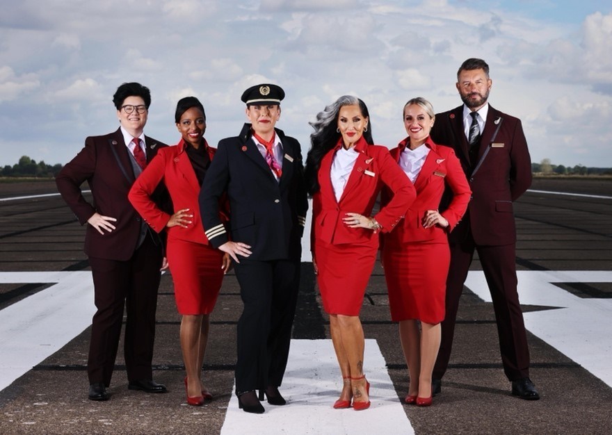 Crew members (left to right) Jamie Forsstroem, Tania Wiks, Alison Porte, Leigh Dixon, Gary Ogden join TV personality, Michelle Visage, to showcase Virgin Atlantic's gender identity uniform policy and pronoun badges, rolled out across the airline for colleagues from today.