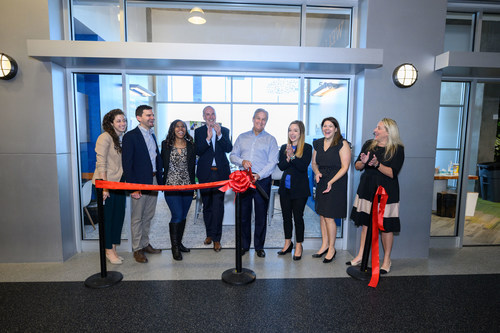 Dallas Clement, president and CFO of Cox Enterprises, center, debuts the new Cox storefront with Cox employees and John Hancock, president and CEO, JA of Georgia.