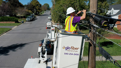 Glo Fiber technician uses bucket truck to install aerial fiber lines.