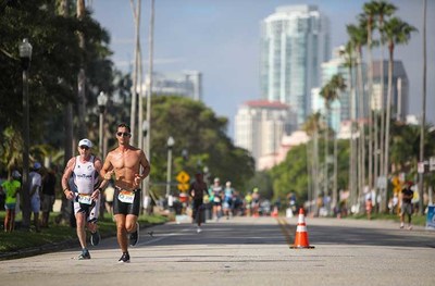 Athletes competing in the 2022 St. Anthony’s Triathlon run on the scenic streets of St. Petersburg.