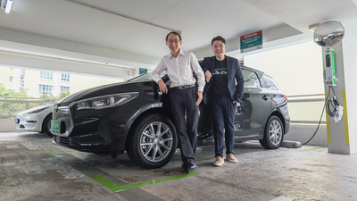 From L to R: Goh Chee Kiong, CEO of Charge+, and Adrian Lee, Co-Founder of Tribecar, in front of Tribecar vehicles at a Charge+ EV charging station