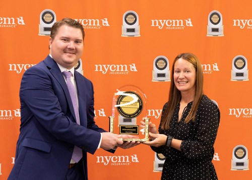 NYCM Insurance President and CEO Cheryl Robinson (right) accepts the J.D. Power Award for Highest Customer Satisfaction from J.D. Power Director of Insurance Intelligence Robert Lajdziak.