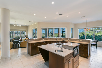 Originally built as the personal home for an area homebuilder, the residence is ideal for entertaining, as shown by the large kitchen. Walls of windows beyond the adjacent dining and living areas provide lovely views of the surrounding preserve. PonteVedreBeachLuxuryAuction.com.