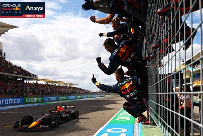 Race winner Max Verstappen of the Netherlands and Oracle Red Bull Racing crosses the finish line as team members celebrate in parc ferme following the F1 Grand Prix of USA at Circuit of The Americas on October 23, 2022 in Austin, Texas. (Photo by Mark Thompson/Getty Images)